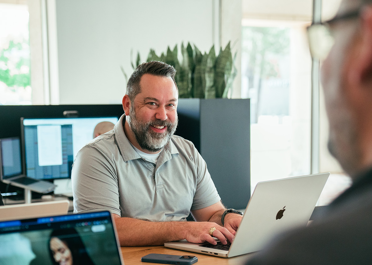 Two business men discuss important things while sitting at a table.