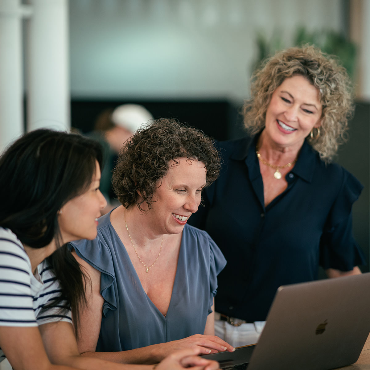 A group of women working together at a table.