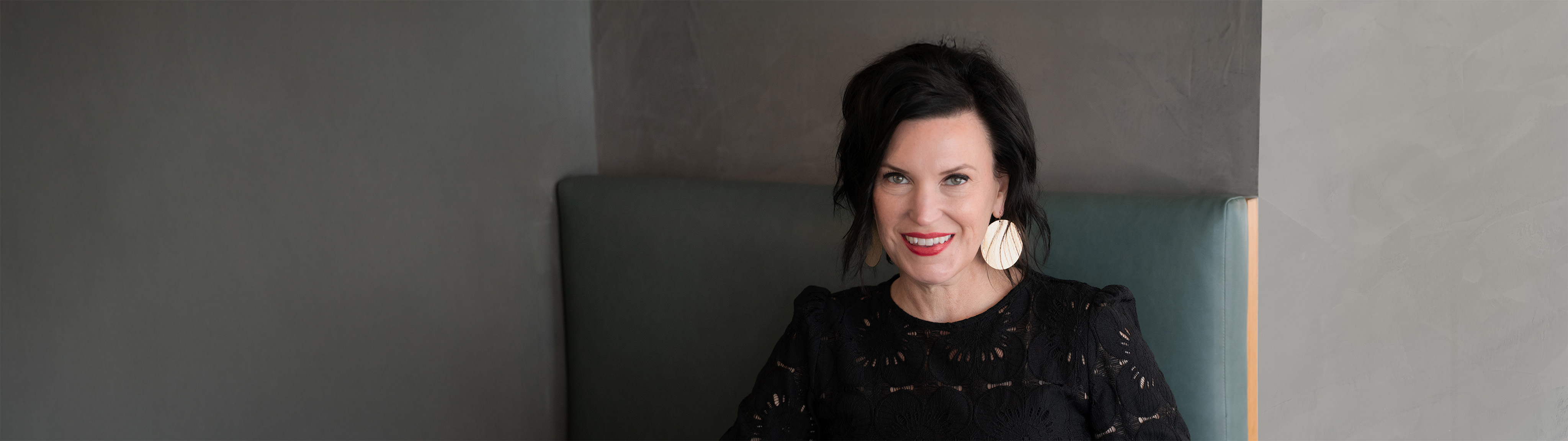 A woman smiling and ready to help you with your website needs.