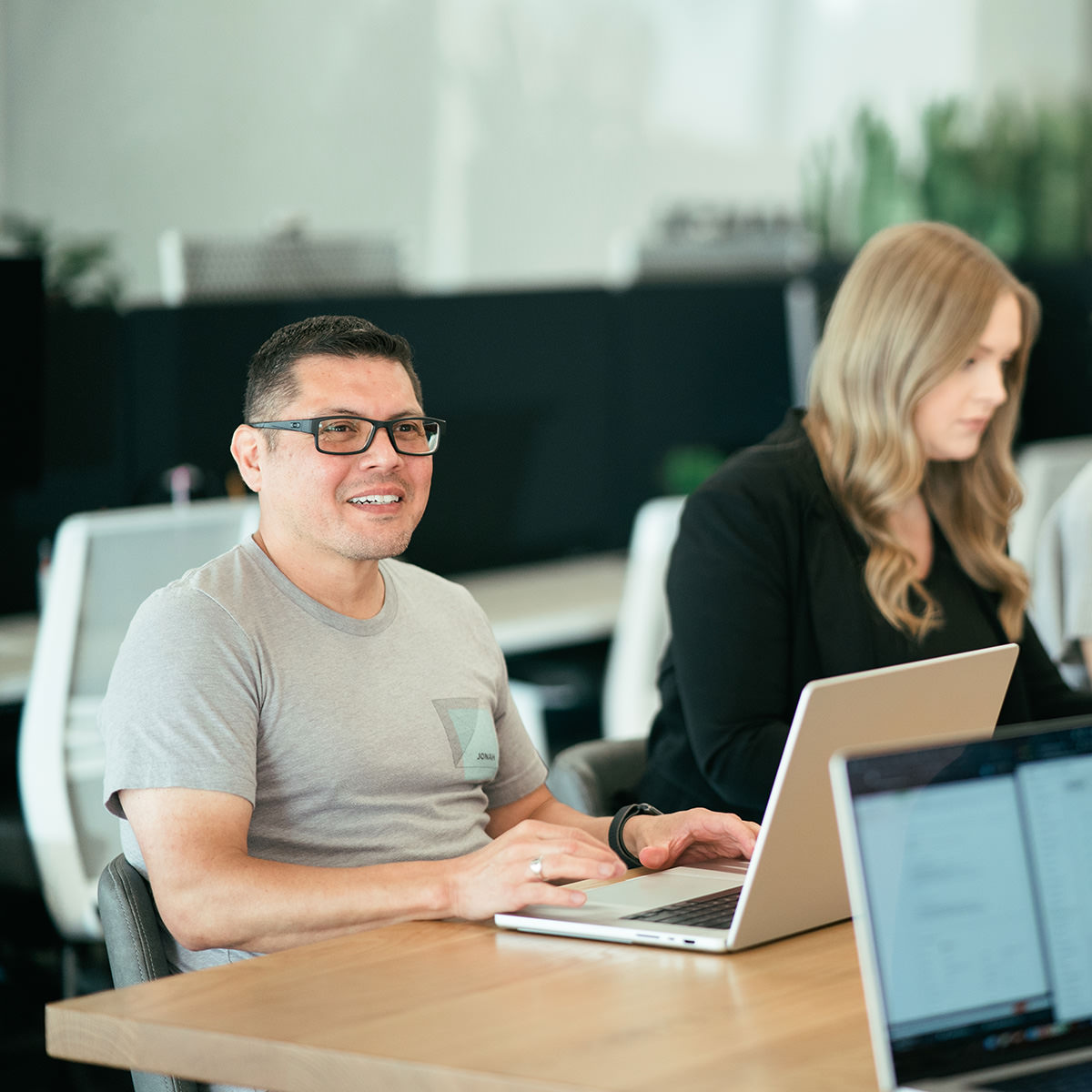 A surprisingly older man working on a laptop computer.