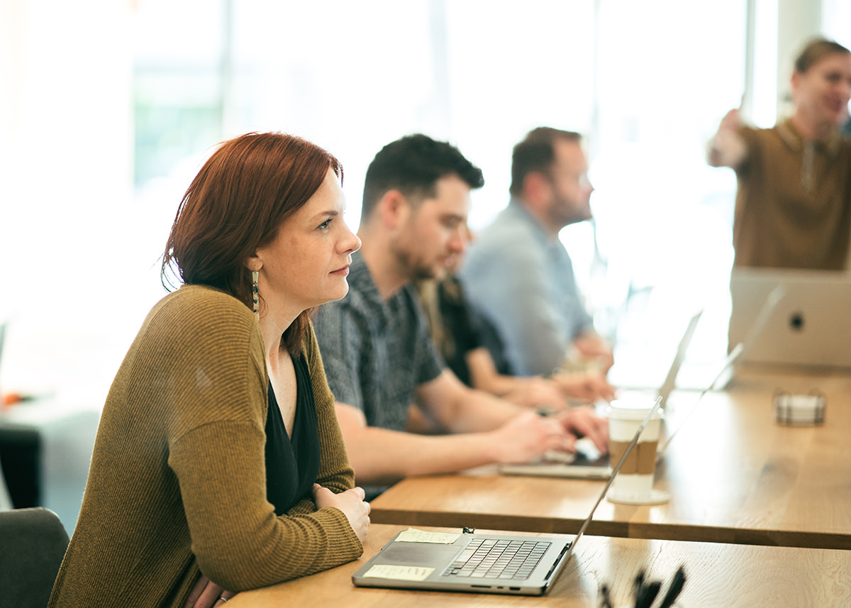 A group of people working at a table.