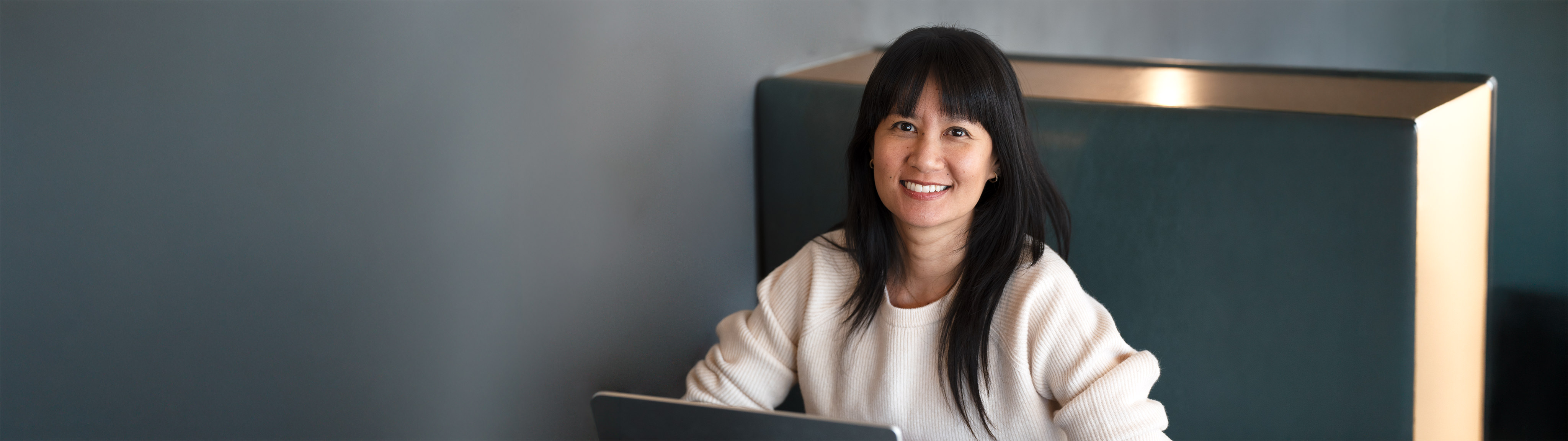 A woman smiling and ready to help you with your website needs.