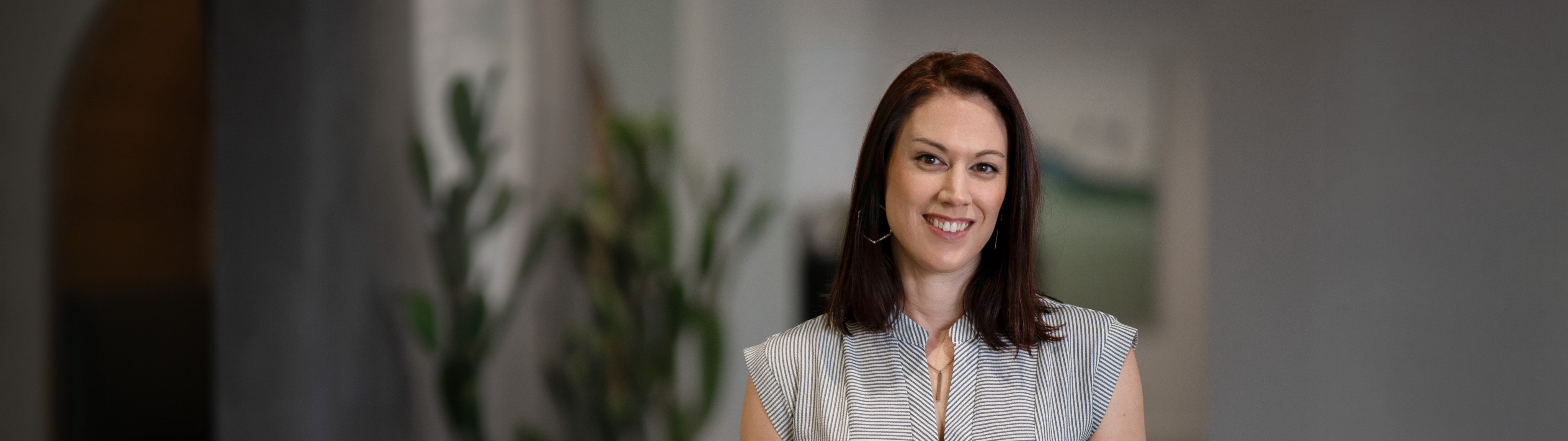 A woman smiling and ready to help you with your website needs.