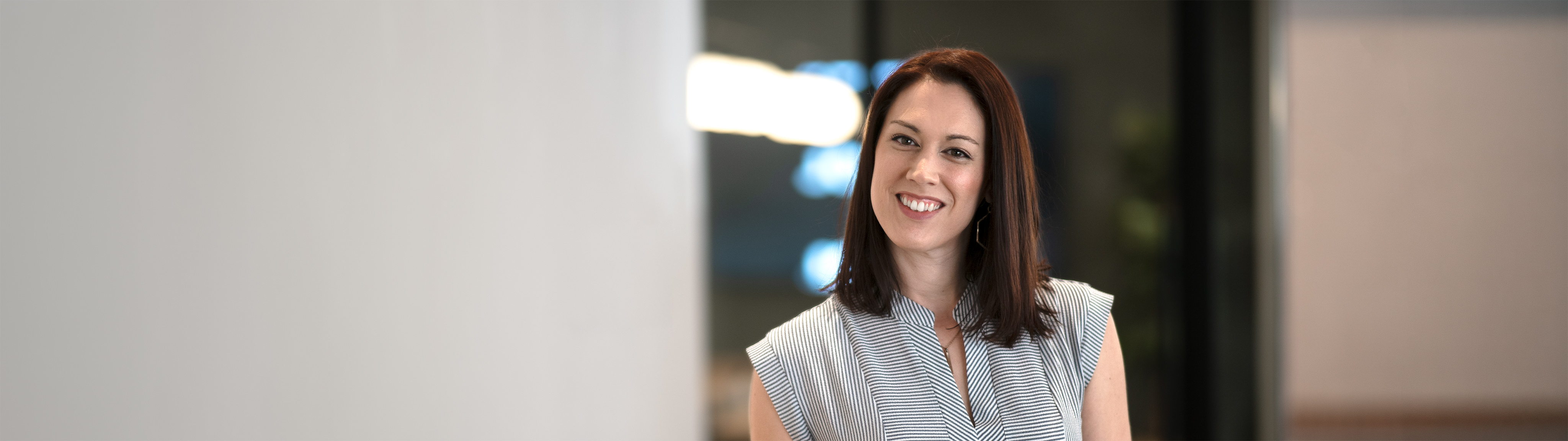 A woman smiling and ready to help you with your website needs.